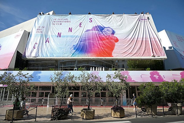 CANNES, FRANCE - MAY 11: Workers install the official festival poster at the Palais de Festival ahead of the 78th annual Cannes Film Festival at  on May 11, 2025 in Cannes, France. (Photo by Thomas Kronsteiner/Getty Images)