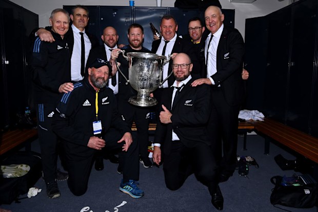 All Blacks coaches including Joe Schmidt celebrate with the Bledisloe Cup in 2022.