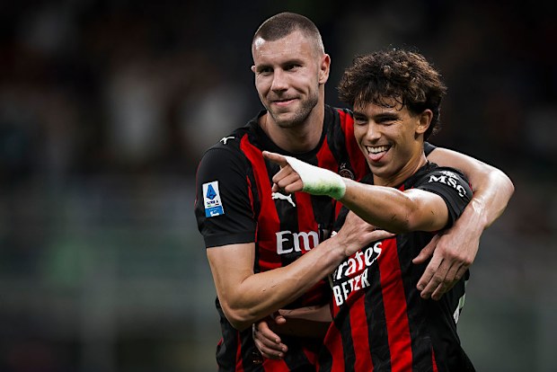 Joao Felix (R) of AC Milan celebrates with Strahinja Pavlovic after scoring a goal.