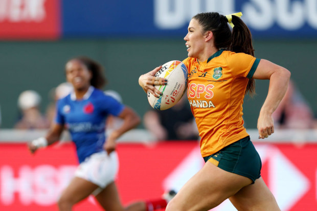 Charlotte Caslick of Australia runs the ball for a try.