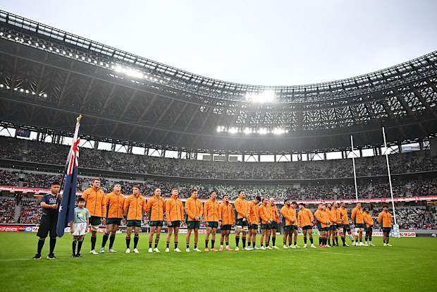 Australia players line up for the national anthem.
