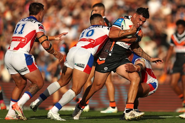 Terrell May of the Wests Tigers is tackled.