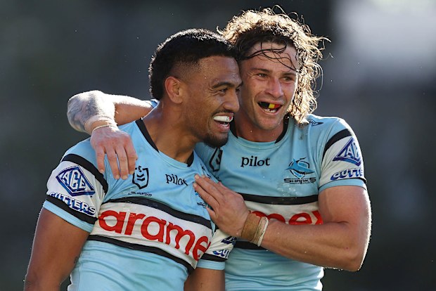 Ronaldo Mulitalo of the Sharks celebrates scoring a try.