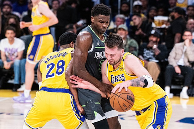 Luka Doncic (77) from the Los Angeles Lakers guarded by Anthony Edwards (5) of the Minnesota Timberwolves.