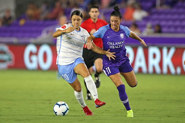 Sam Kerr #20 of Chicago Red Stars and Ali Krieger #11 of Orlando Pride fight for the loose ball.