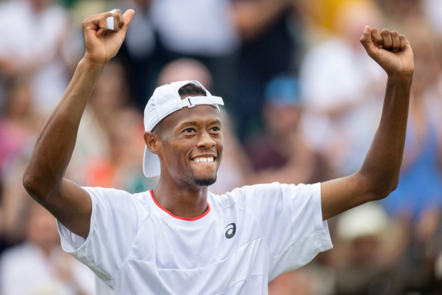 Christopher Eubanks celebrates his five-set victory against Stefanos Tsitsipas in the fourth round at Wimbledon.