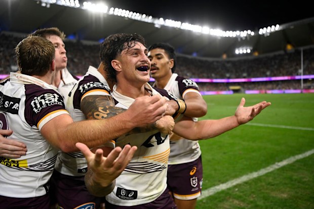 Kotoni Staggs of the Broncos celebrates after scoring a try.