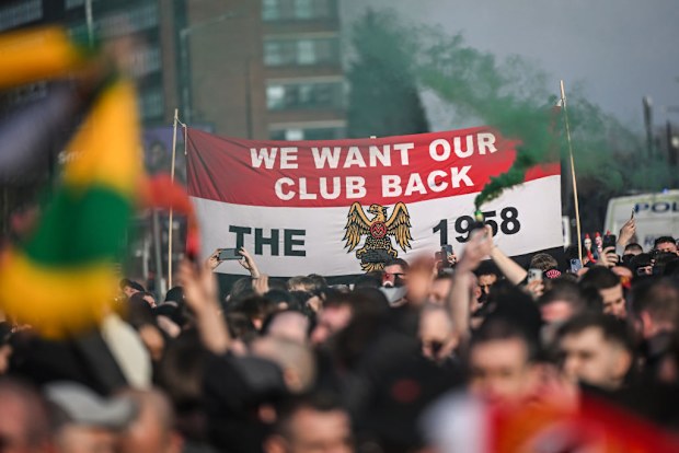 Manchester United fans protest against the Glazers ownership of the club outside The Tollgate pub.