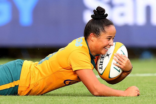 Nicole Ledington of the Wallaroos scores a try.
