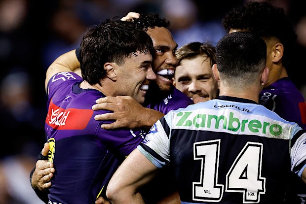 Xavier Coates of the Storm celebrates scoring a try.