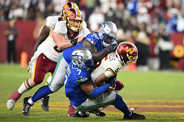 Jayden Daniels #5 of the Washington Commanders tackled.