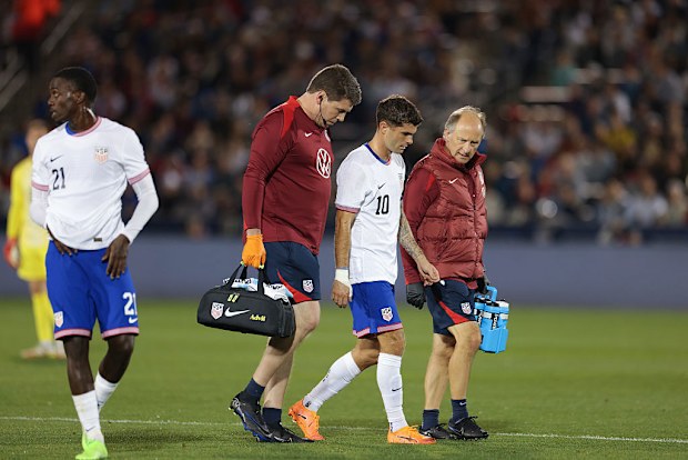 Christian Pulisic of the United States leaves the game after picking up an injury.