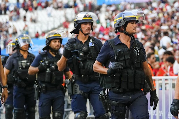 Police are seen near the pitch during a men's semifinal soccer match between Morocco and Spain at the 2024 Summer Olympics, Monday, Aug. 5, 2024, at Marseille Stadium in Marseille, France.