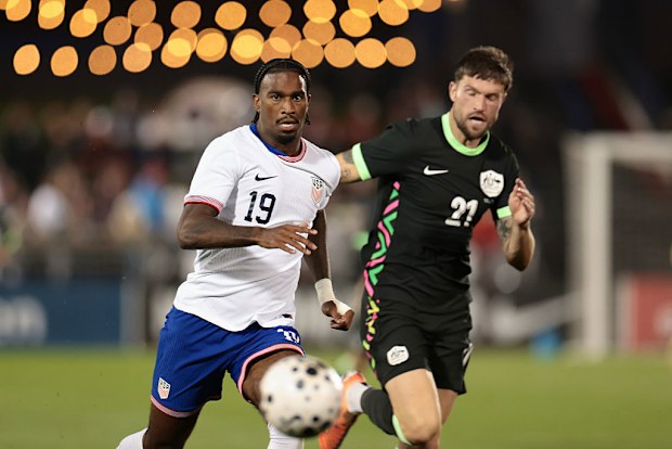 Haji Wright of the United States is chased by Cameron Burgess of Australia.