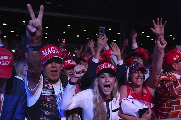 Supporters watch returns at a campaign election night watch party for Republican presidential nominee former President Donald Trump at the Palm Beach Convention Center, Wednesday, Nov. 6, 2024, in West Palm Beach, Fla. (AP Photo/Evan Vucci)