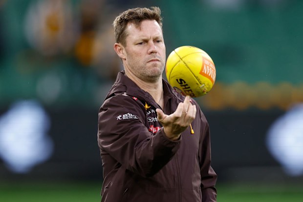 Sam Mitchell, Senior Coach of the Hawks looks on.