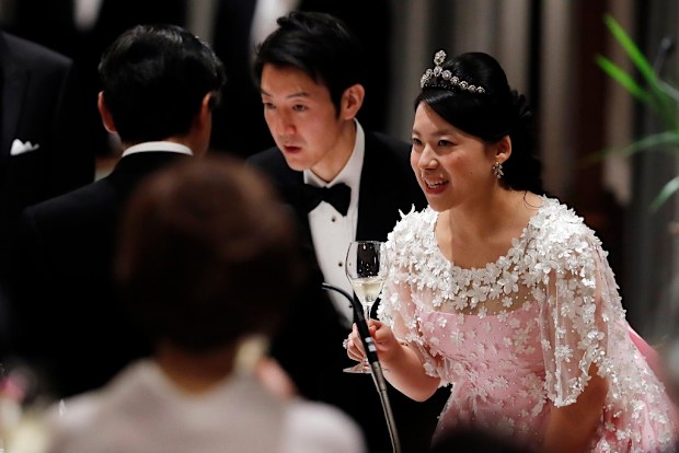 Japan's former princess Ayako Moriya (R) and her husband Kei Moriya (C) toast with Crown Prince Naruhito at their wedding banquet in Tokyo, Japan, October 28, 2018.  