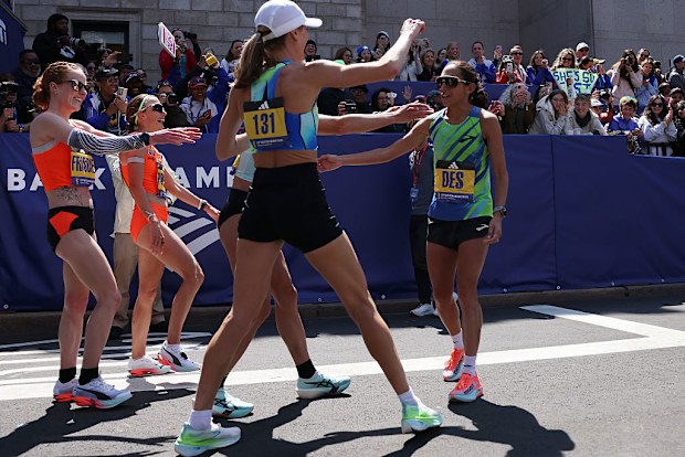 Des Linden is greeted by teammates after crossing the finish line of the 129th Boston Marathon. Linden, the 2018 Boston Marathon champion, has announced that the 2025 Boston Marathon will be her final professional marathon. 