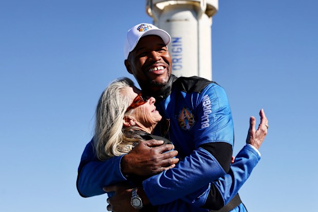 Good Morning America co-anchor and former NFL star Michael Strahan embraces Laura Shepard Churchley, daughter of astronaut Alan Shepard.
