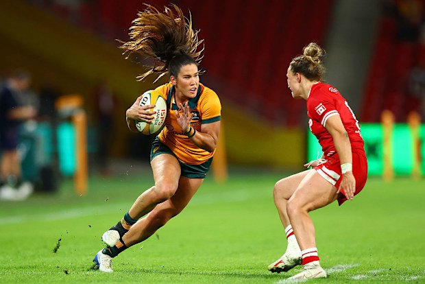 Charlotte Caslick of the Wallaroos runs with the ball.