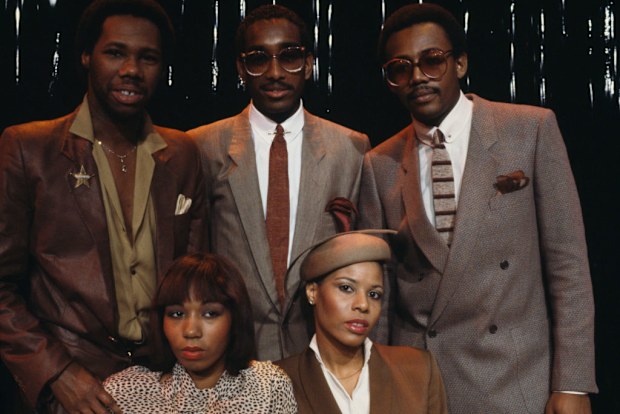 American band Chic on the set of a french tv show. In the background, from left to right : music producer, songwriter, composer, and arranger, Nile Rodgers, drummer Tony Thompson, bassist and also music producer, songwriter, and composer, Bernard Edwards. In the foreground, singers Luci Martin (L) and Alfa Anderson. France, 30th January 1979. (Photo by James Andanson/Sygma via Getty Images)