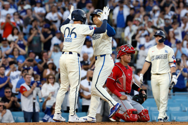 Shohei Ohtani celebrates with Cavan Biggio (left) after hitting a two run homer run.