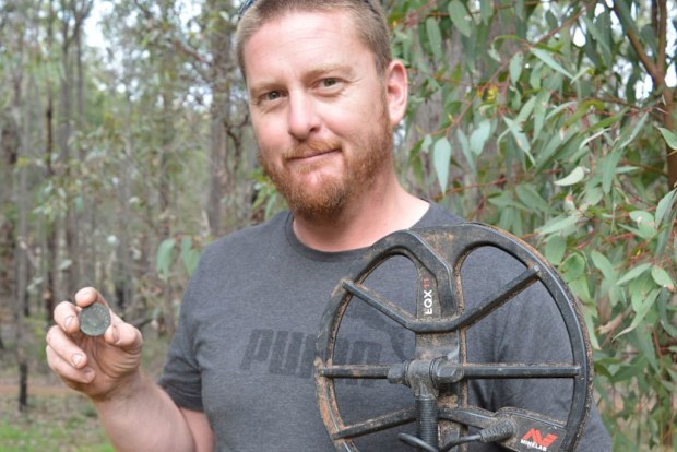 Metal detectorist Rhys Hall, pictured with a love token made by Stephen Stanley Parker - one of West Australia's first white settlers - in 1837.