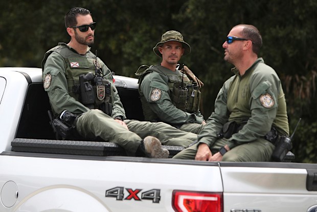 Law enforcement officers enter the T. Mabry Carlton Reserve in North Port Fl in a continued search for Brian Laundrie.