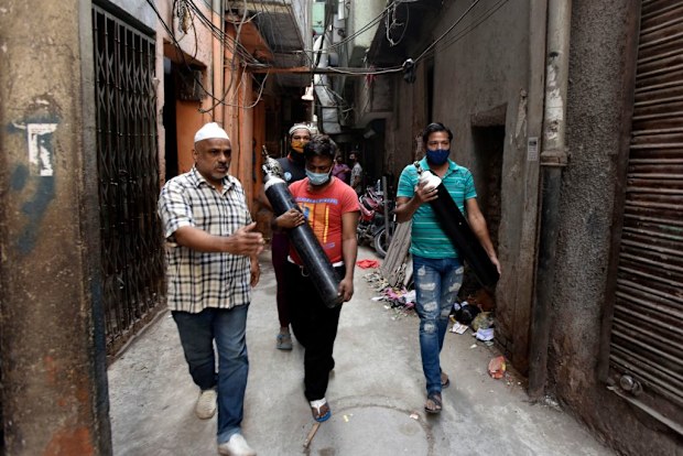Free oxygen cylinders are distributed by the Resident Welfare Association (RWA) Turkman Gate for Covid-19 patients at Gali Ahata Meer Bukhari in New Delhi.