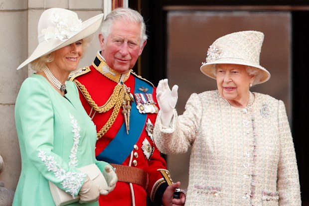 Camilla, Prince Charles, and the Queen watch a flypast from the balcony of Buckingham Palace during Trooping The Colour in 2019.