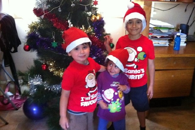 Children standing in front of a Christmas tree