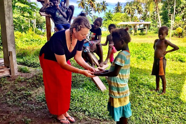 Dr Lucia Romani working with children in the Pacific.