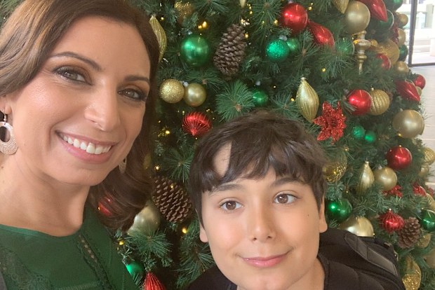 Jo Abi and son Philip standing in front of a Christmas tree
