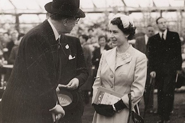 Queen Elizabeth speaks with officials during one of her first appearances at the Chelsea Flower Show.
