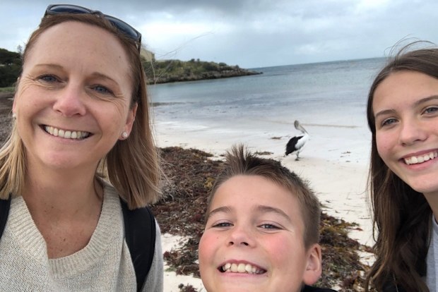 Tracey Lewis on a beach with her children