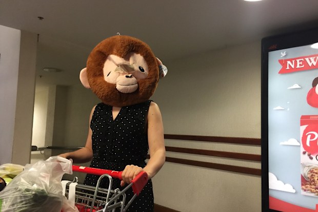 Mum grocery shopping wearing gorilla head