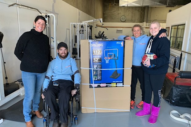 Molly (far right) with her physiotherapist Ryan Medley (second from left) who is a quadriplegic. 