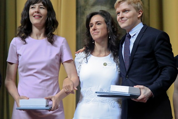 Megan Twohey, left, Jodi Kantor, centre, and Ronan Farrow accept their 2018 Pulitzer Prize awards.