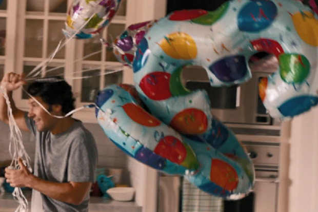 Paul Rudd in the movie This is 40 carrying balloons for wife's birthday.