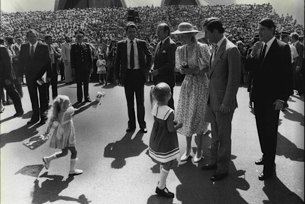 A little girl races in to present her tribute to the Princess of Wales, outside the Sydney Opera House. 