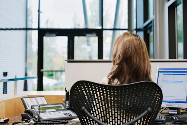 Receptionist sitting at desk
