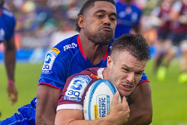 Isaac Henry of the Reds runs with the ball.