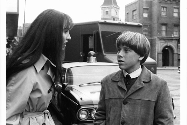 Susan Kendall Newman talks with Christian Juttner in front of a patrol car in a scene from the film 'I Want To Hold Your Hand', 1978. (Photo by Universal Pictures/Getty Images)