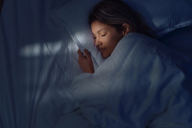 Woman in bed asleep - sleep research.