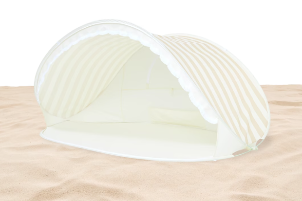 The $50 Pop-Up Beach Shelter in Natural Stripe is going viral on social media after one TikTok user showed her using the tent. 