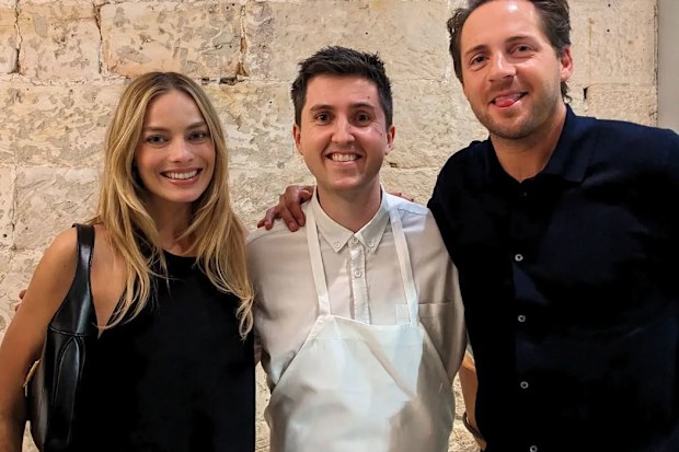 Josh Niland poses for a photo with Margot Robbie and Tom Acklerley