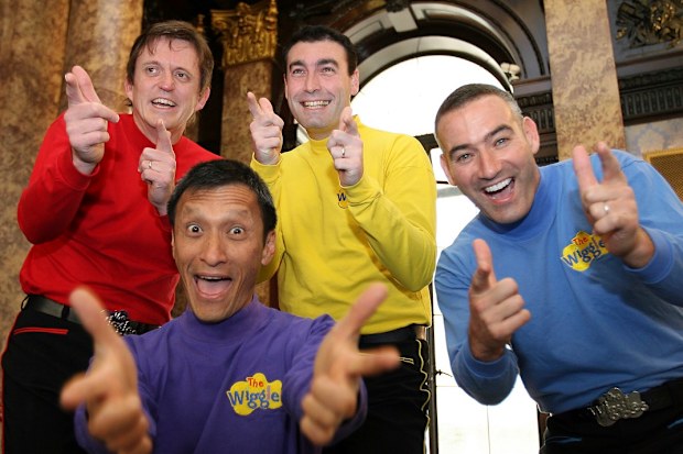 FILE - In this June 28, 2006 file photo, Australian children's entertainers The Wiggles, Murray Cook (Red Wiggle), Greg Page (Yellow Wiggle), Jeff Fatt (Purple Wiggle), and Anthony Field (Blue Wiggle) make a special appearance at the Australian High Commission in London at the start of their UK tour. Page, one of the original members of the popular Australian children's band has been hospitalized after collapsing during a wildfire relief concert.  Page fell as he left a stage in New South Wales 