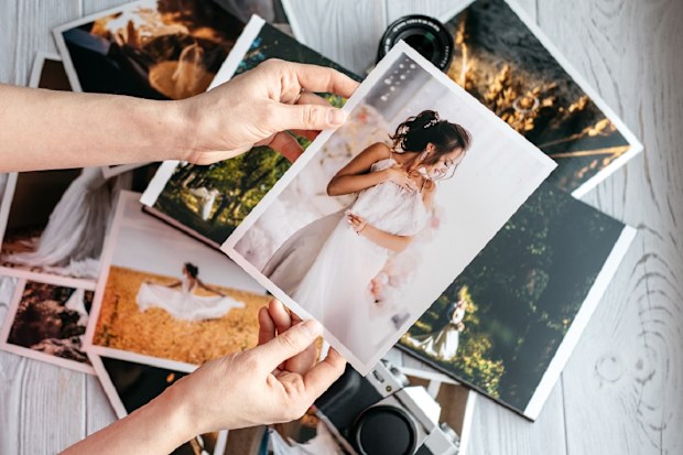bride looking at wedding photos