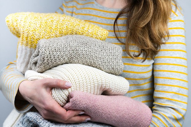 Woman holding jumpers