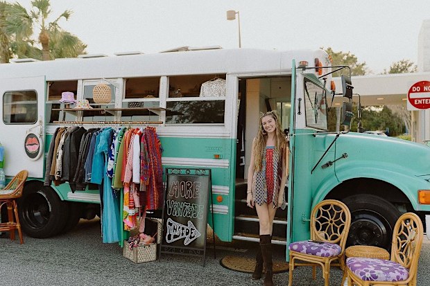 Sara Bartlett with her school bus that is a mobile clothes shop.